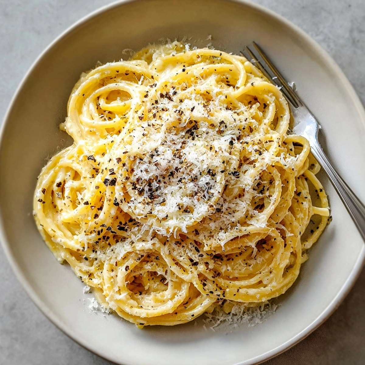 Indulge in the rich Cacio e Pepe Plus, a vegetarian delight with shaved truffle, ready to be served.