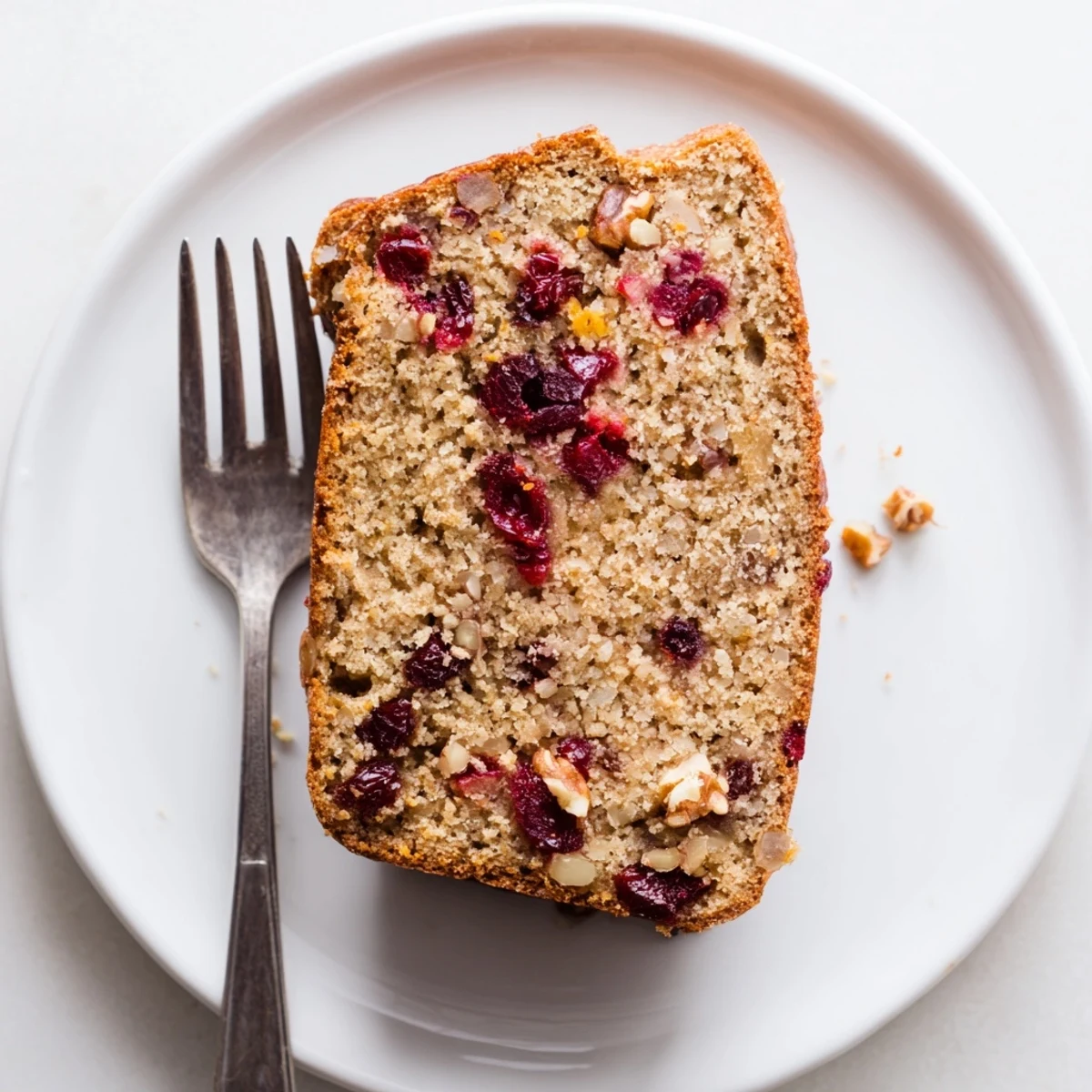 Festive Ginger Cranberry Dutch Holiday Snack Loaf slice topped with orange zest.