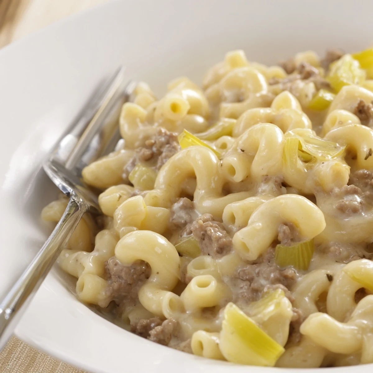 Creamy leek beef macaroni topped with fresh parsley and a savory sauce.  