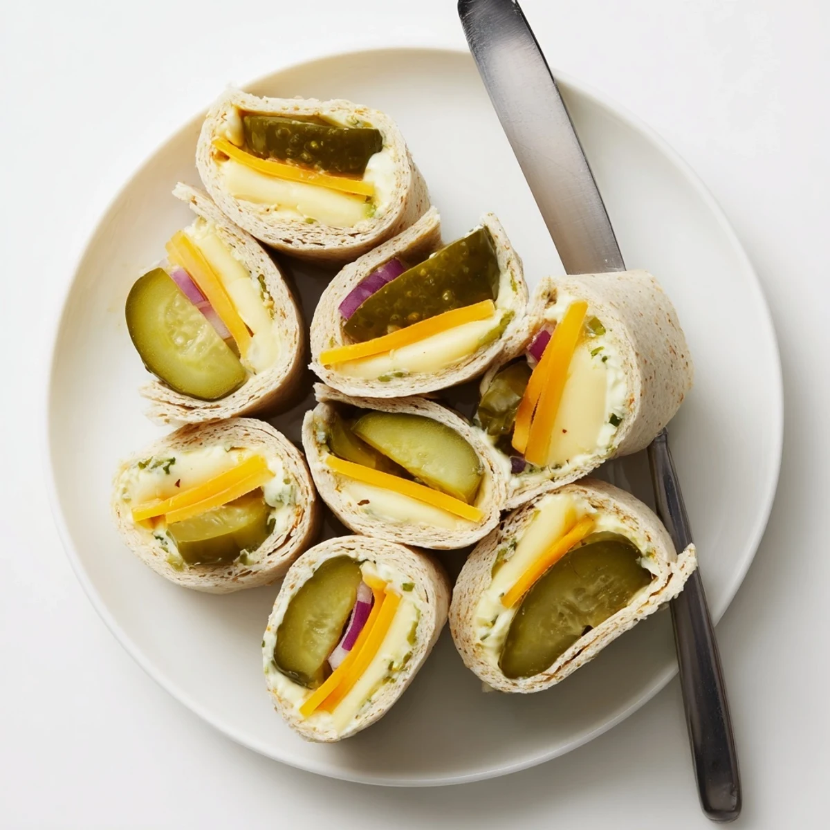 Crispy Pickle-in-a-Blanket snack, savory cheese wrapped in soft tortillas, party-ready delight.  