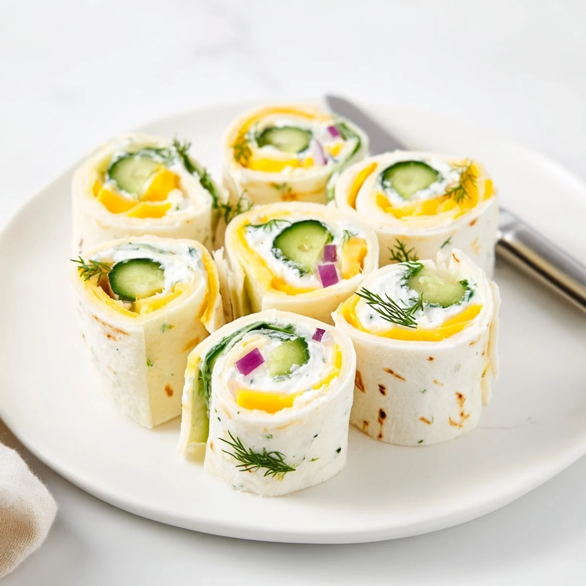 Tangy Pickle-in-a-Blanket appetizers, creamy cheese and pickles rolled in flour tortillas.  