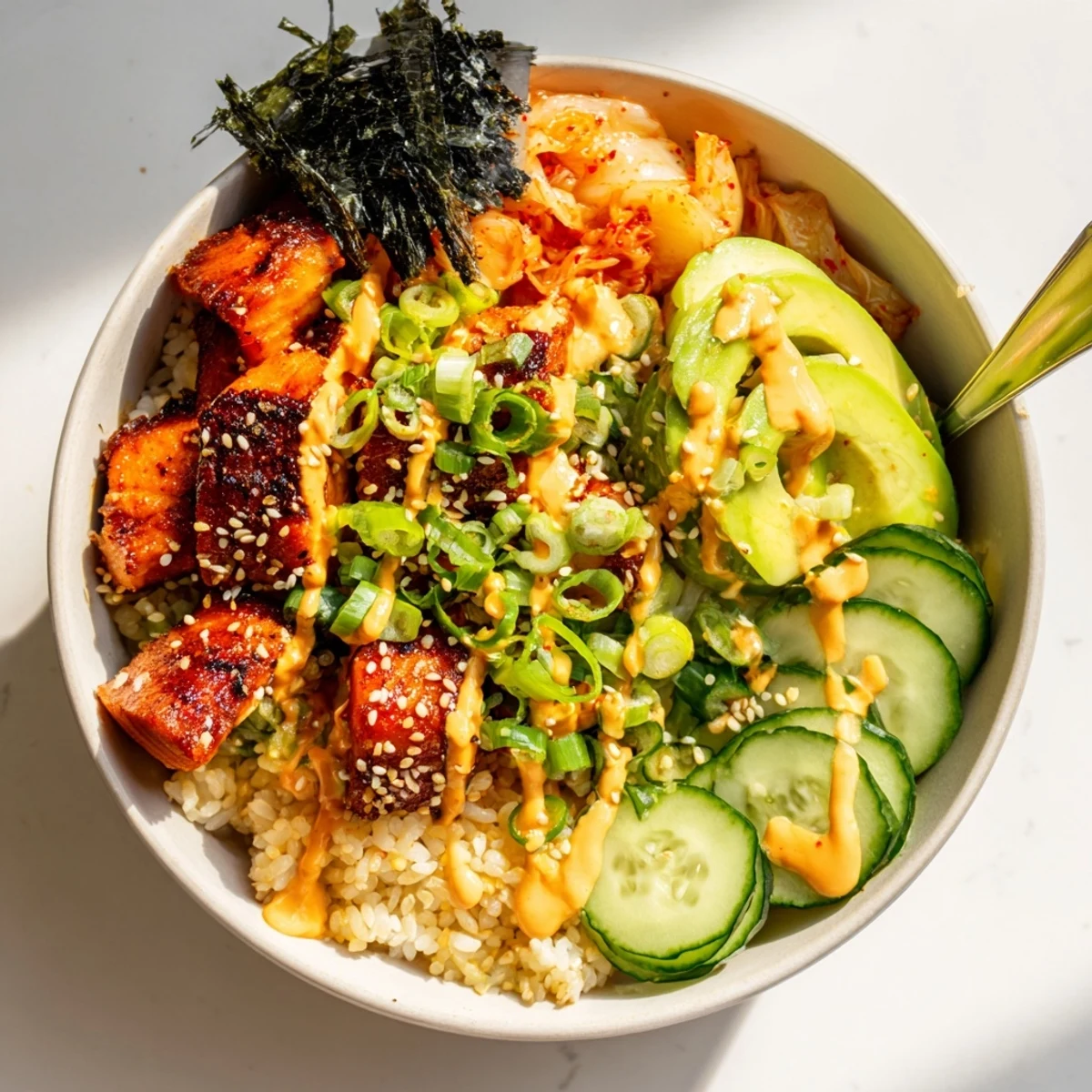 Deliciously crispy salmon rests on warm rice with garlic and fresh veggies.  