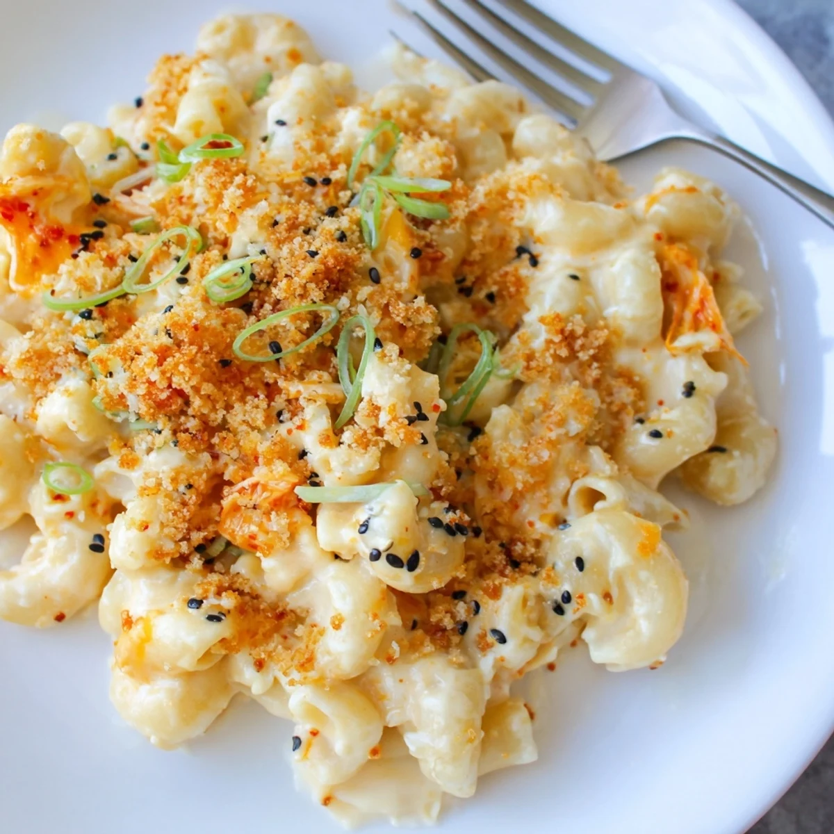 Creamy Spicy Kimchi Mac & Cheese topped with crunchy sesame for vibrant flavors.  
