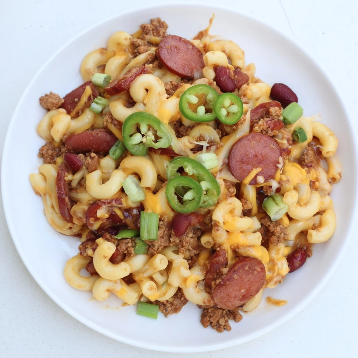 Freshly baked Chili Cheese Dog Mac & Cheese, close up, showing the texture of the melted cheese.