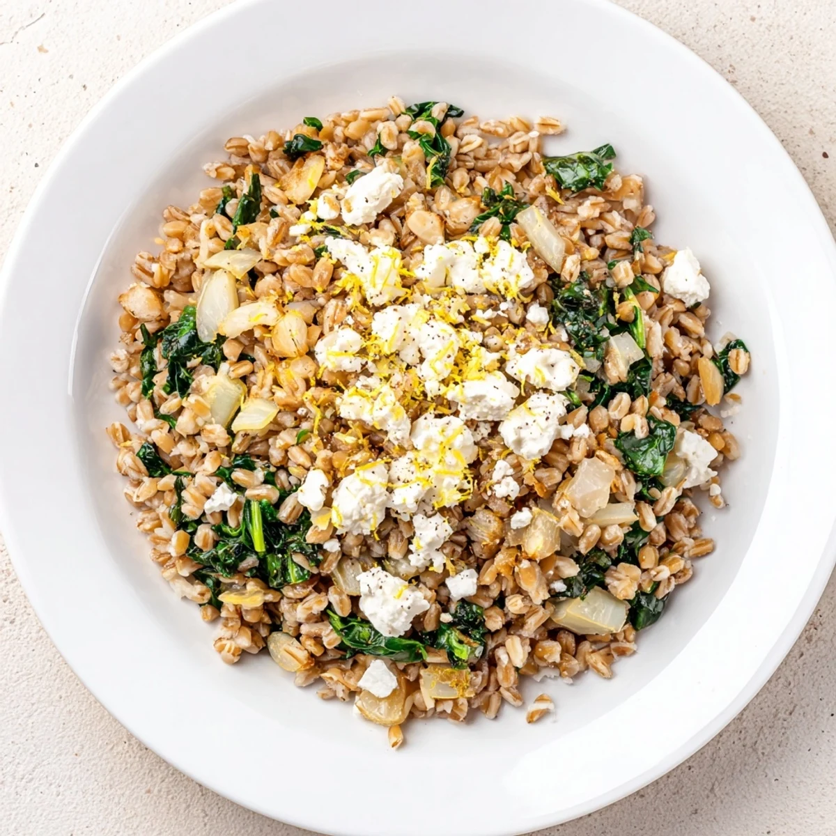 Close-up of a delicious serving of Farro & Greens Pilaf, ready to enjoy as a vegetarian meal.