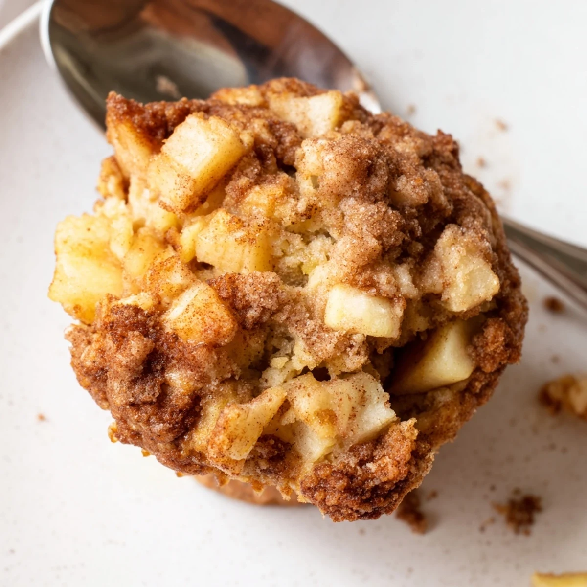 Freshly baked Cinnamon Apple Muffins, golden brown and enticing, ready for a warm breakfast treat.