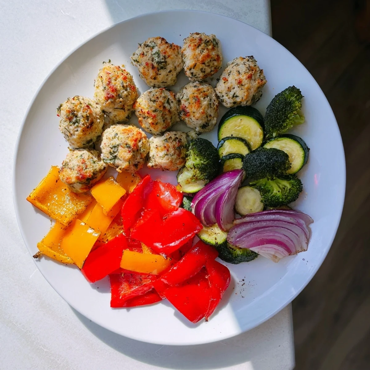 Golden, roasted Garlic Parmesan Chicken Bites on a sheet pan with colorful, tender vegetables, ready to serve.