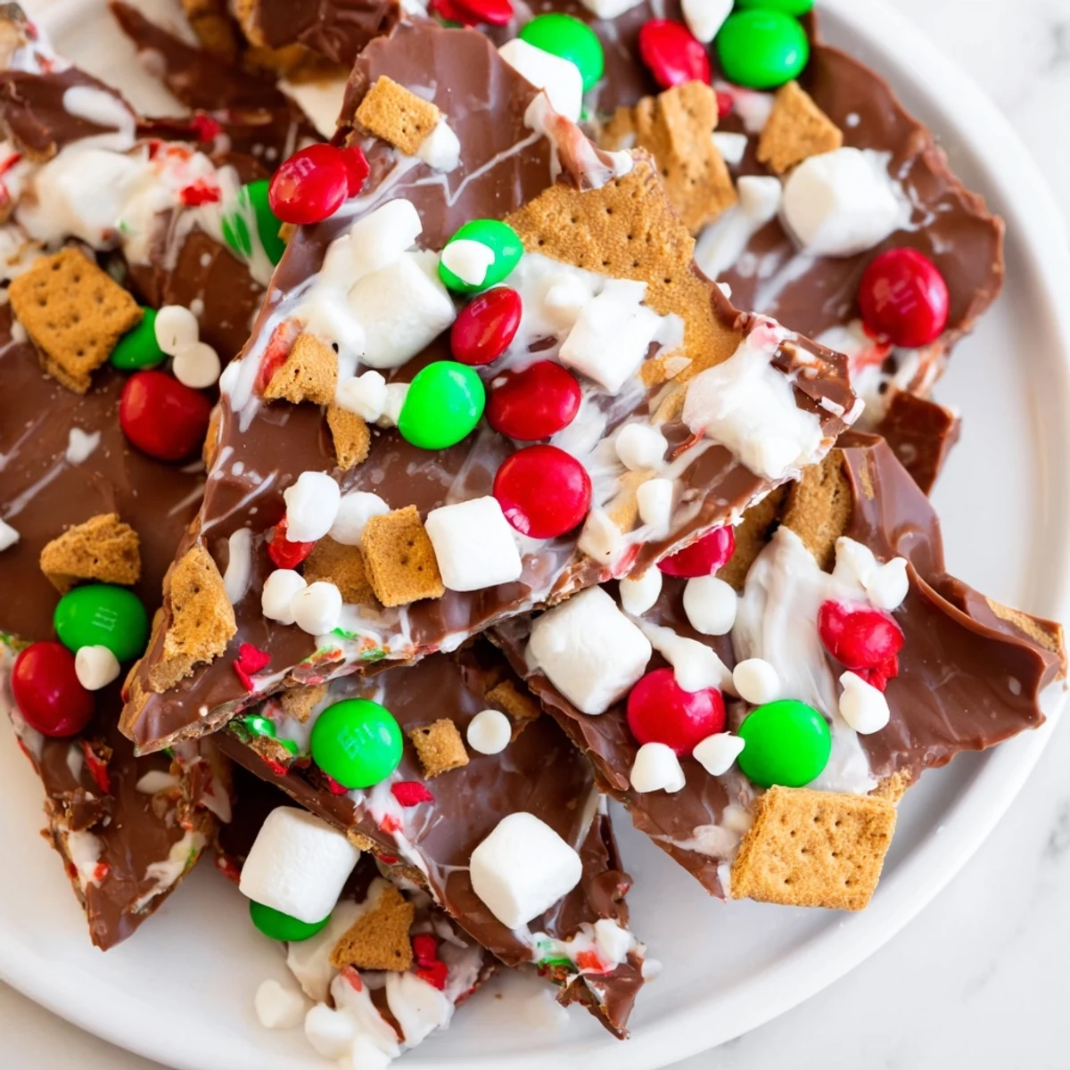 Quick Christmas Smores Bark: A close-up of festive bark with graham crackers, marshmallows, and colorful sprinkles.