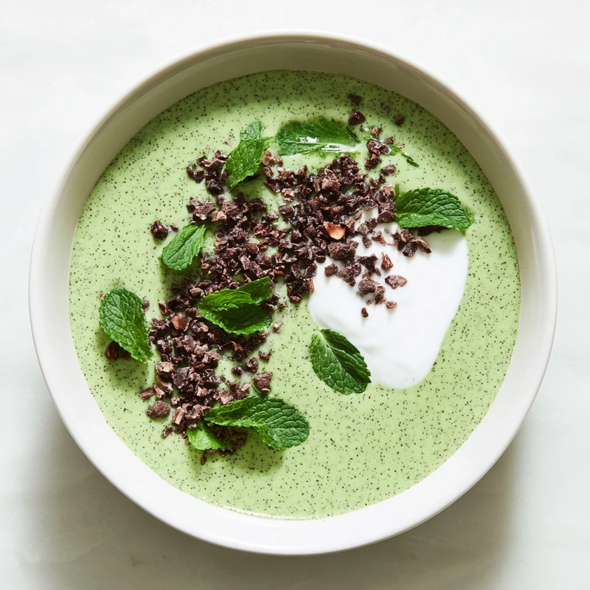Enjoy a spoonful of creamy Grinch Green Mint Matcha Breakfast Chia Pudding, a festive and healthy breakfast option.