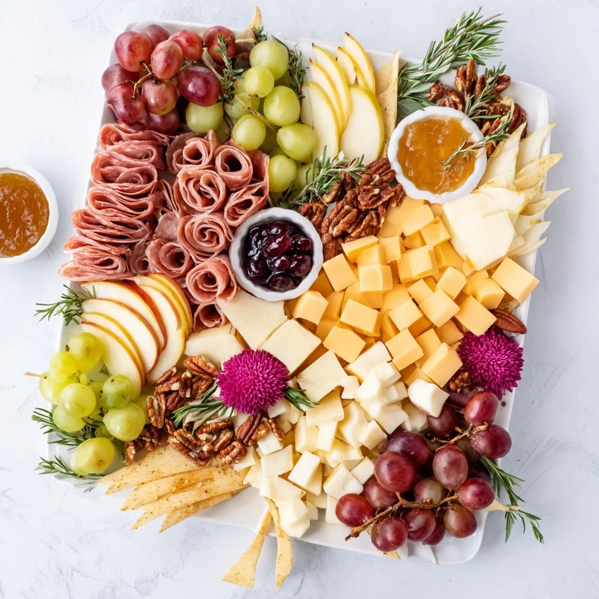 Vibrant Maple Leaf Grazing Tray bursting with colorful fruits, cheeses, meats, and crackers for autumn entertaining.
