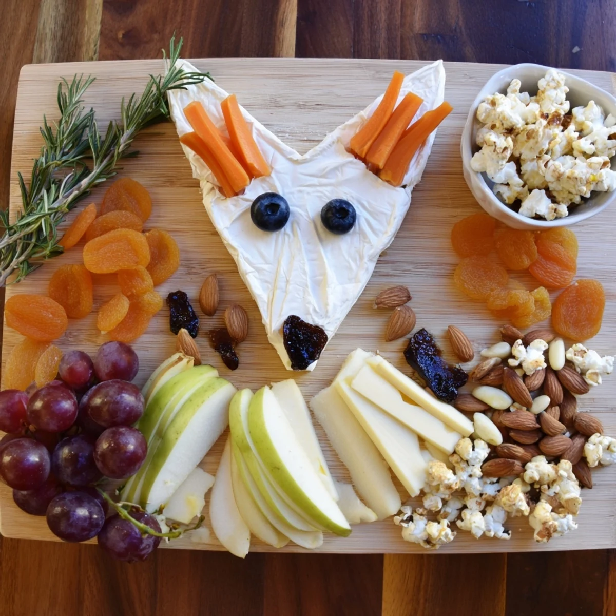 A visually stunning Whimsical Fox Fall Treat Board displaying autumnal cheeses, fruits, crackers, and sweet snacks.