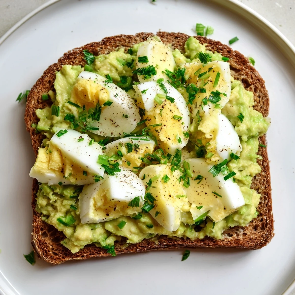Creamy Avocado Egg Smash on toasted whole-grain bread, ready for a healthy breakfast.