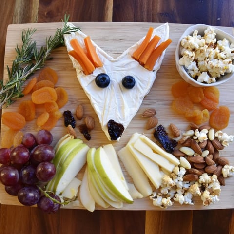 A visually stunning Whimsical Fox Fall Treat Board displaying autumnal cheeses, fruits, crackers, and sweet snacks.