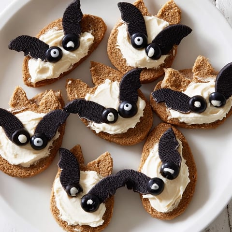 Flying Bat Halloween Snack Board loaded with savory crackers and sweet Oreo bats.