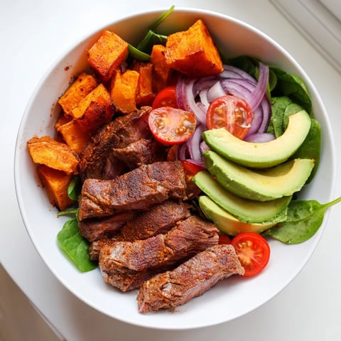 Beef Avocado Sweet Potato Bowl with tender beef, creamy avocado, and roasted sweet potatoes arranged beautifully.