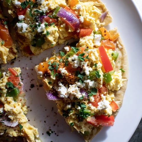 A beautiful Turkish Menemen Eggs Pizza, ready to serve with a bubbly, cheesy, flavorful topping.