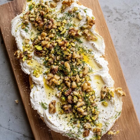 Creamy Flavored Butter Board with nuts, herbs, and honey, ready to serve with bread.