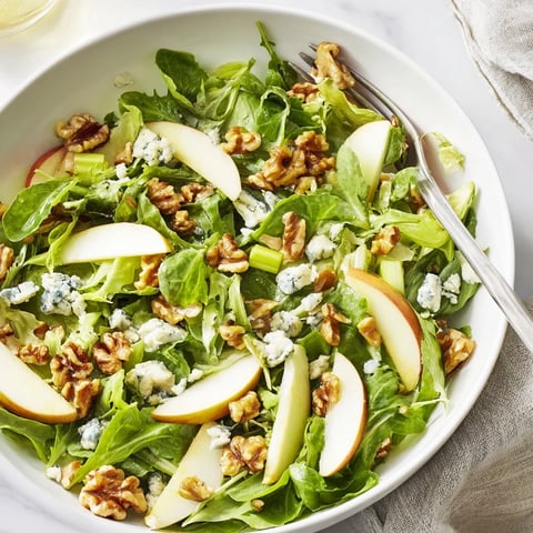 Freshly sliced crisp apples and toasted walnuts tossed with mixed greens in a tangy vinaigrette, topped with crumbled blue cheese.