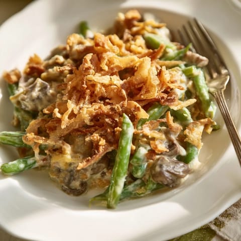 Creamy Old-School Green Bean Casserole topped with crispy fried onions, a holiday favorite.  