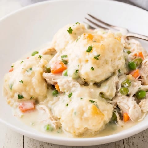 Golden Chicken and Dumplings Casserole topped with fluffy dumplings, perfect comfort food for dinner.  