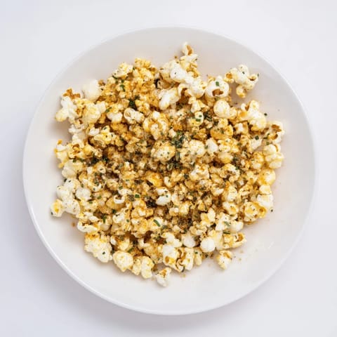 A close-up of delicious savoury popcorn mixes boasting a variety of flavorful seasonings and textures.