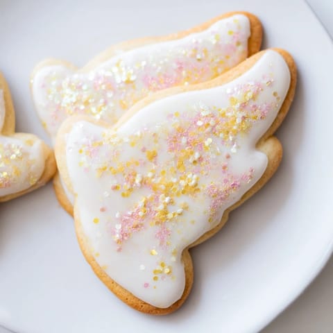 Golden-edged Angel Wings Sugar Cookies, freshly baked and arranged artfully for dessert.