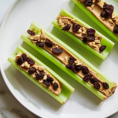 Freshly assembled peanut butter celery sticks, showing a close-up of the easy, healthy snack.