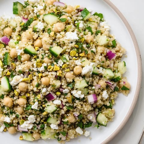A refreshing bowl of Jennifer Aniston Salad, featuring bright cucumbers and crumbled feta cheese.