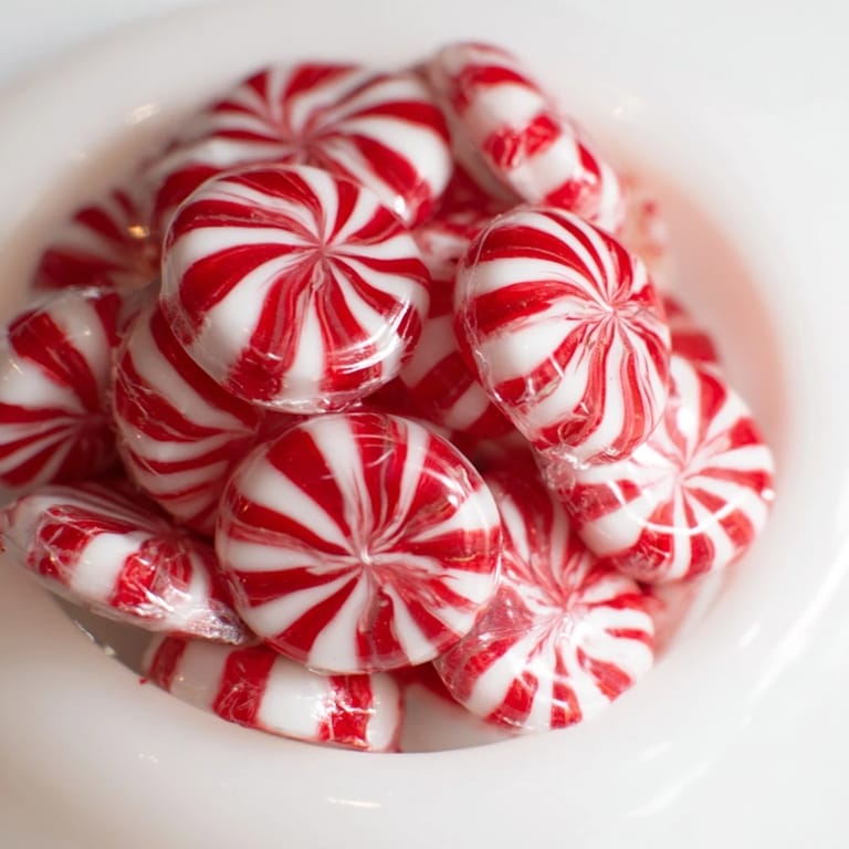 Shaping the glossy, sweet No-Bake Peppermint Candy Bowl from melted peppermint rounds with ease.