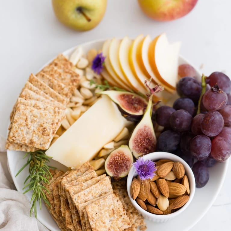 Beautiful Golden Wheat Bundle Board appetizer showcasing cheese, apple slices, grapes, and almonds for a party.
